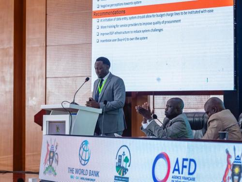 GKMA-UDP Coordinator for Mpigi delivering a presentation on valuing and tracking in-kind and community contributions and, addressing procurement and eGP challenges at the GKMA-UDP Midterm Review.